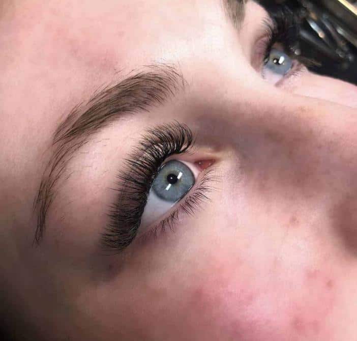 A woman after getting eyelash extensions by Frame Lash Studio in Oakville, ON.